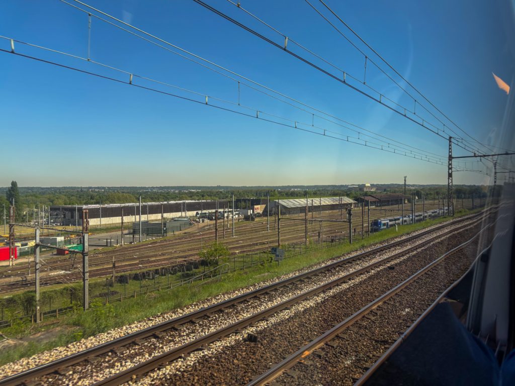 Rail yard views with Versailles in the background.